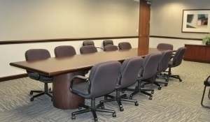 image of a conference room with a long table and chairs all around it