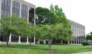 Image of buildings from the outside with trees in front