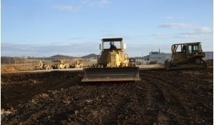 image of a large tractor plowing on a development site